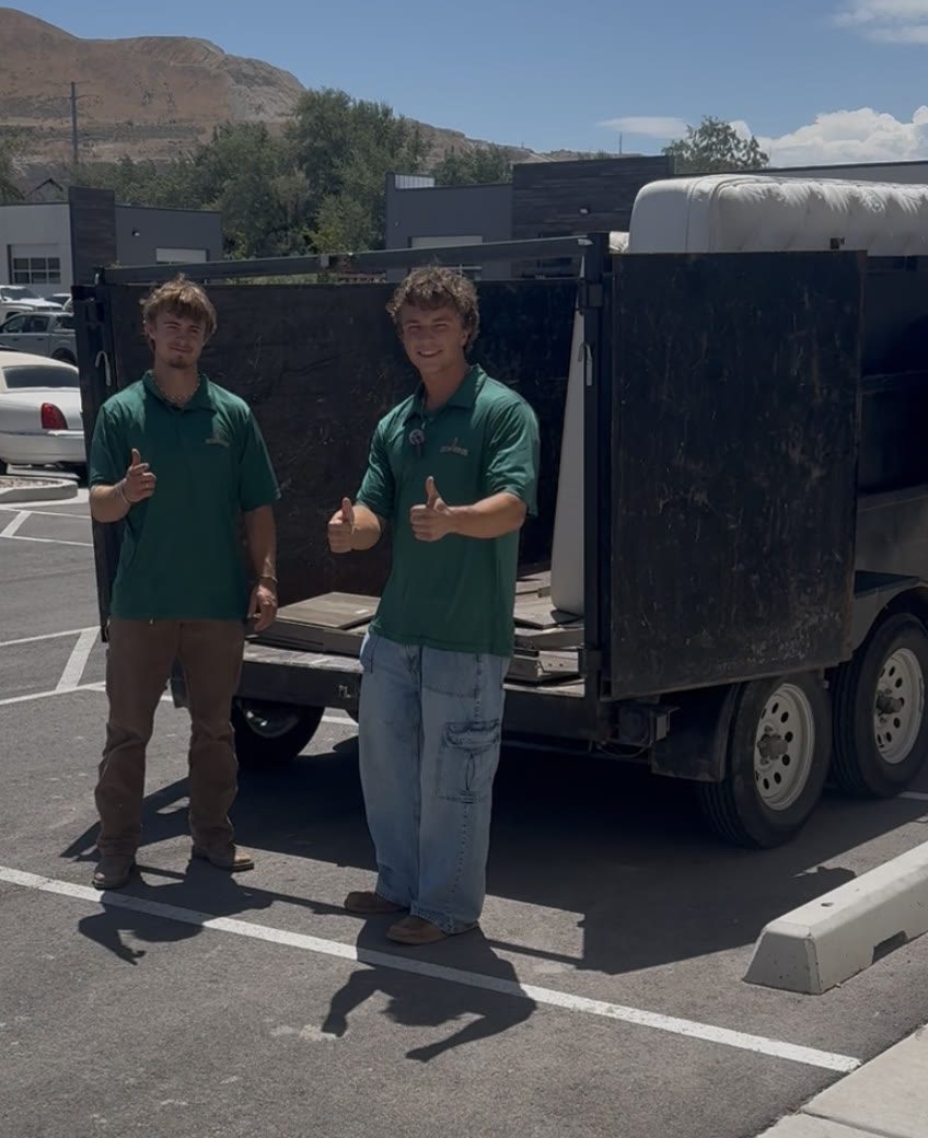 Mason and Landon, the Junk-A-Saurus crew, by the dump trailer